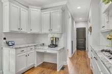 The Laundry Room is on the right down the hallway that leads to the back stairway and up to Bonus Room.  The door at the end of the hallway leads directly to the Garage.