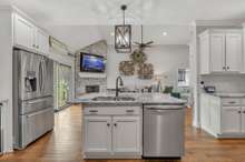 This kitchen is large enough to accommodate an Island which hosts an informal eating area.