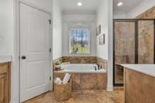 Separate tile Shower & Tub are encased by 2 Vanities and a private Water Closet.