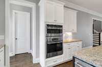 Double oven, top is an Advantium oven. Door leading to walk-in pantry