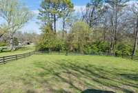 Fenced in area backing to private tree line. Property line extends beyond the trees.