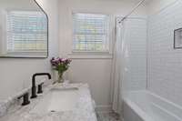 Secondary hall bath with tiled shower and tub.