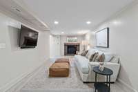 Basement level family room with wood burning fireplace.