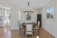 Charming dining room with designer light fixture. Corner cabinets do not convey.