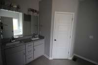 Double vanity with granite counter tops and tile floors!