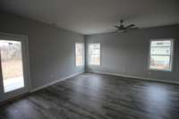 Large living area with access to covered patio! Lots of natural lighting! LVP flooring!