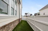 Pet Friendly turf on the side of the home with a separate gate