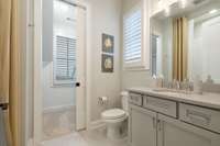 Bathroom with pocket door leading to walk in closet