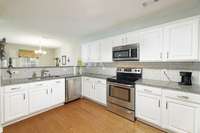 Bright white cabinets with subway tile backsplash.