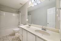 Full bath upstairs with double vanities and tub/shower combo.