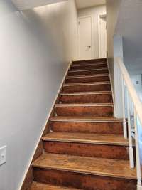 Stairs going up. Linen closet at top of stairs and largest bedroom to the right of the linen closet.