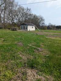 Shed behind the house that is almost complete and you can remodel it to fit your needs.