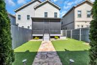 A turfed lawn offers low maintenance and always looks great. Note the flagstone pavers.