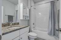 Another clean and classic bathroom with shower tub combination and neutral pallette.