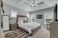 A light filled primary suite offers tray ceiling and fabulous yours and mine walk in closets.