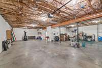 1800 sqft garage with room for two cars. Industrial wood burning stove.
