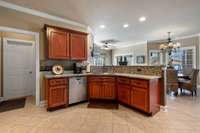 Kitchen has bar and dining area with bay window