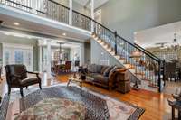 View of great room toward formal dining room and 2nd story balcony hallway.