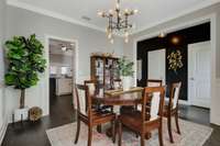 The formal dining room has been updated with modern light fixtures and crown box moulding.