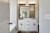 Bathroom ensuite features double vanities, a garden soaking tub, and large tile shower.