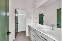 Shared secondary bathroom with double vanities and tub/shower