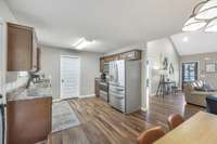 just cooked up in this sweet open kitchen with detailed raised panel wooden cabinets, pretty counters...