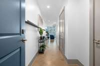 Long Elegant entryway shows off the beautiful herringbone wood flooring and has plenty of wall space to display your favorite art works