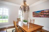 Formal dining room looking out the front windows