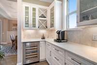 Butlers pantry with wine fridge and extra cabinets and counter space