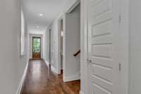 Furthest door on the right is the mud room, followed by the downstairs powder room, stairs and then pantry.