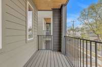 Balcony off the kitchen with Trex decking and custom metal railing for relaxing outdoors