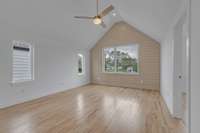 Bonus room on third level with large windows and ceiling fan