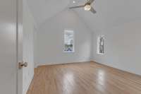 Primary Suite on third level with vaulted ceiling, hardwoods, and ceiling fan