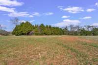 Property goes beyond tree line.