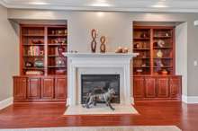 Living room with gas fireplace and built in book shelves.