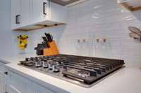 Gas cooktop in kitchen with backsplash