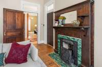 A superb green-tiled fireplace in the secondary living room.