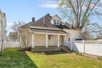 The rear of the home is just as charming as the front, with a gracious back porch and fully fenced yard.