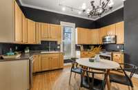 The kitchen is modern and spacious and features extensive cabinetry.