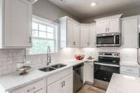 Granite counters and tile backsplash are the perfect add to this space.