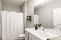 The guest bathroom is located conveniently next to the guest room.