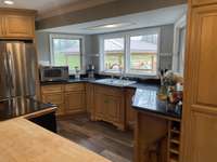 Looking out the back, windows that crank open - goes out to the '22 outdoor kitchen & pool. New frig/dishwasher bought in '18, great condition. Sink is only thing that was not updated which you may want to do in time. All kitchen appliances remain.