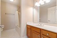 Full second bathroom with shower/tub combo, large vanity.