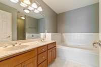 Primary bathroom suite with soaking tub, walk-in shower, double vanities.