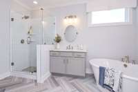 Owner's Bath with separate vanities, tile shower, and stand alone tub. Photo is of similar floorplan, not actual home.