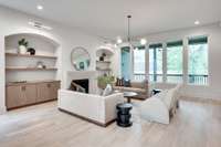 Built-ins, cabinets, lights, and this fireplace all add so much character to this room.