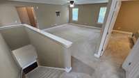 Stairs leading to bonus room and the four bedrooms