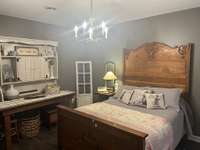 Primary bedroom that features walk in closet, full bath and French doors that lead to covered patio .