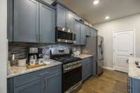 Stainless appliances are a great addition to this kitchen and it is a rare find to get a gas cooktop!