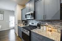 Granite counters and the tile back splash really finish off this great kitchen.